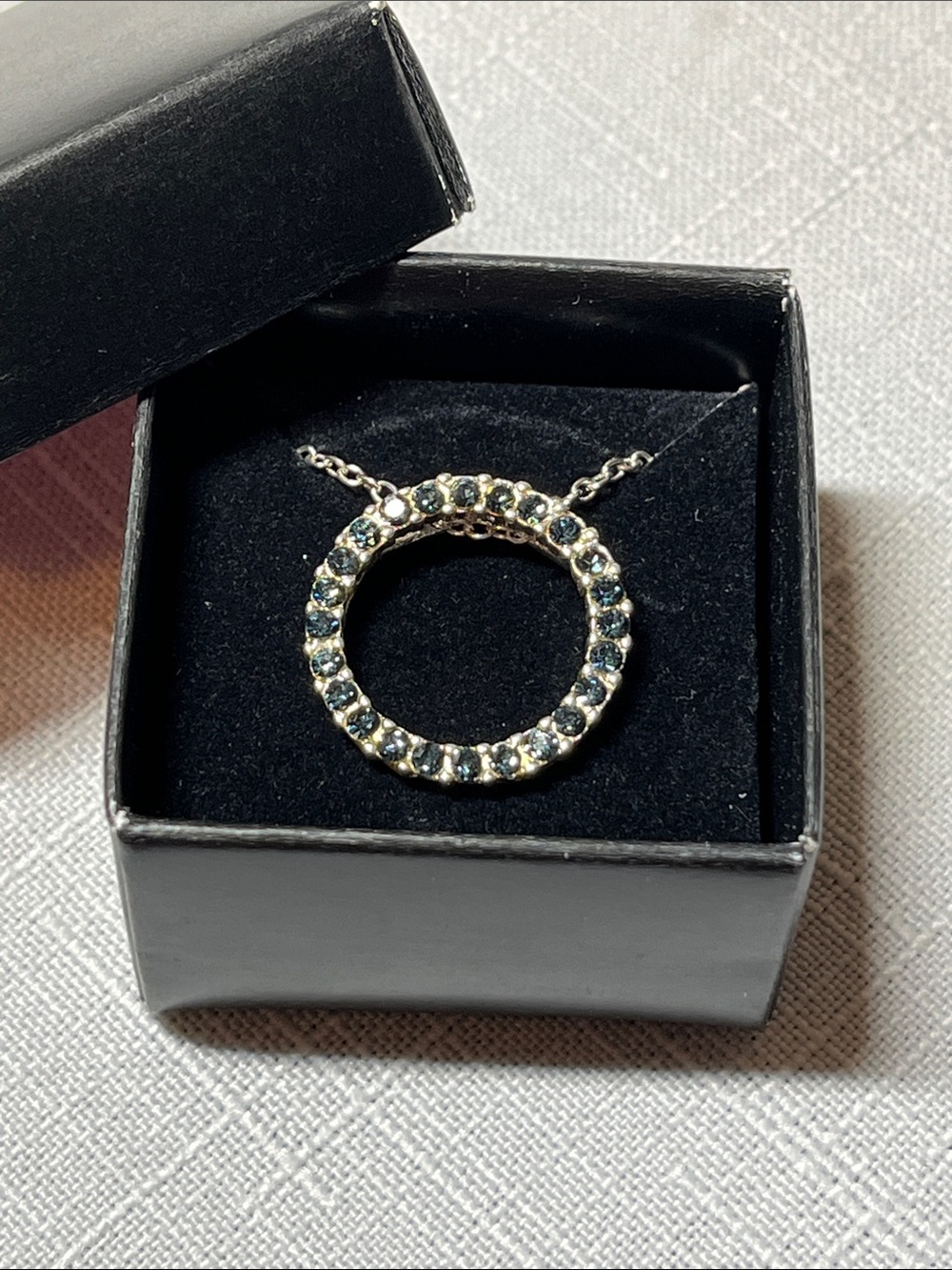 New AVON Silver Circle Pendant Necklace with dark Blue Stones
Box included